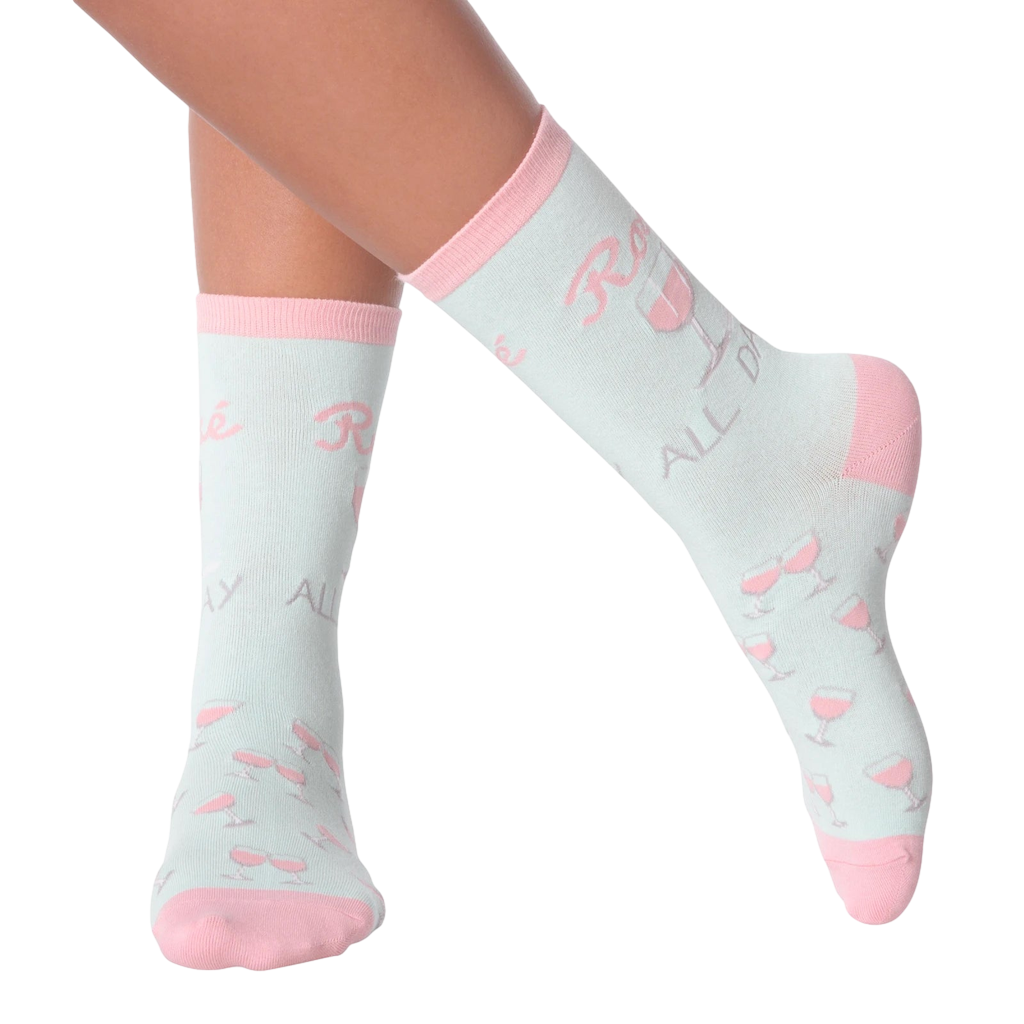 Lifestyle shot of woman's legs wearing 'Rose All Day' socks.