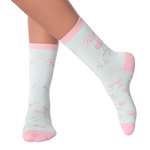 Lifestyle shot of woman's legs wearing 'Rose All Day' socks.