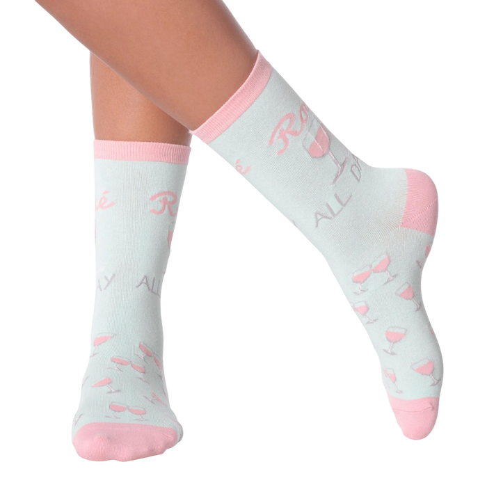 Lifestyle shot of woman's legs wearing 'Rose All Day' socks.