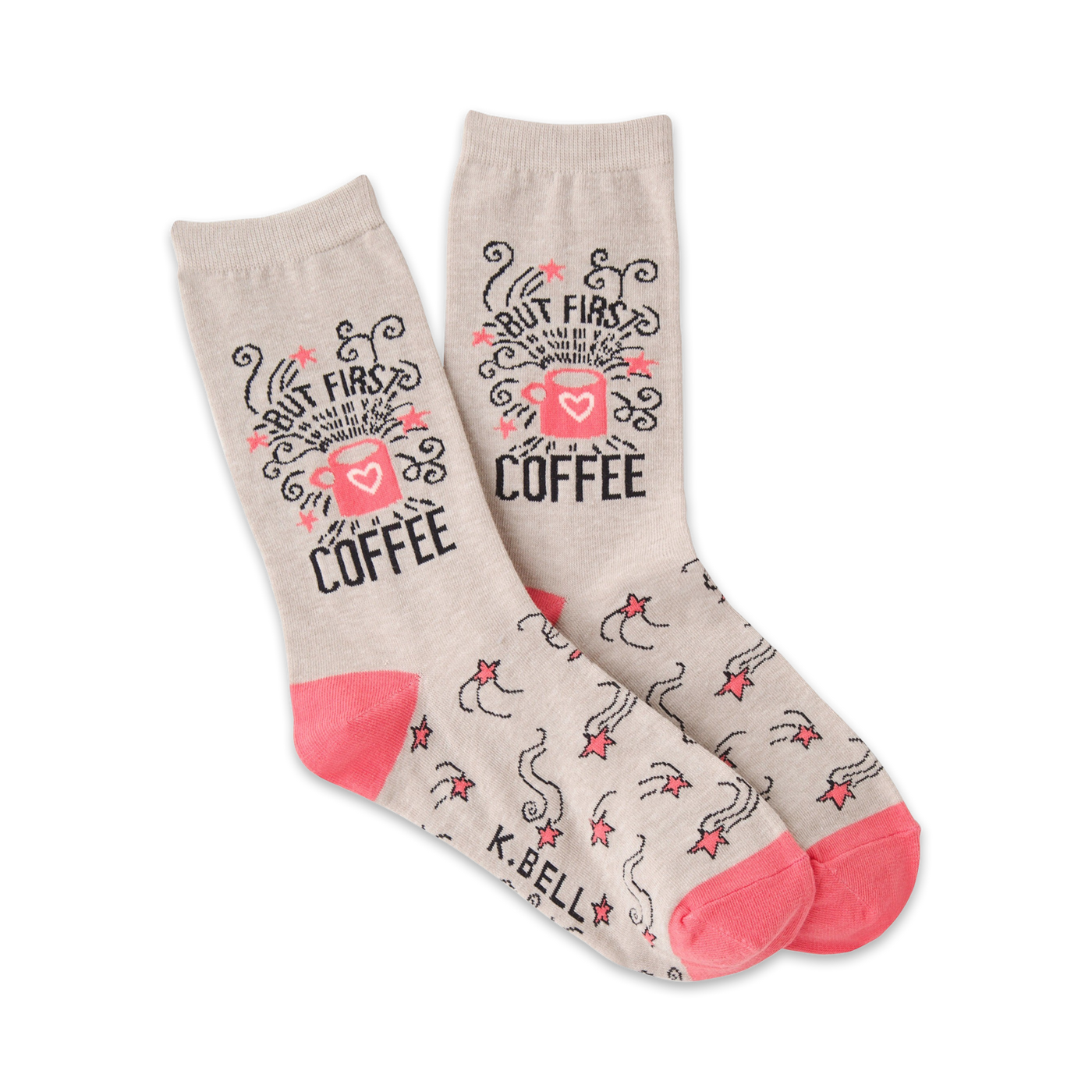 A pair of beige crew socks with a pink coffee cup design and shooting stars. The text 'But First, Coffee' is prominently displayed.