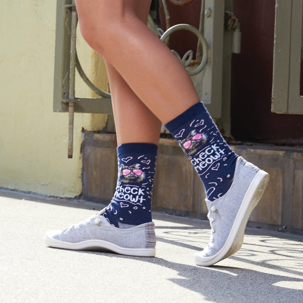 Person wearing the socks and light grey canvas shoes walking outdoors. [lf]