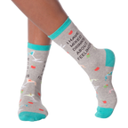 Lifestyle shot of woman's legs wearing the 'I Have Mixed Drinks About Feelings' socks, showing the fit and style on the feet.