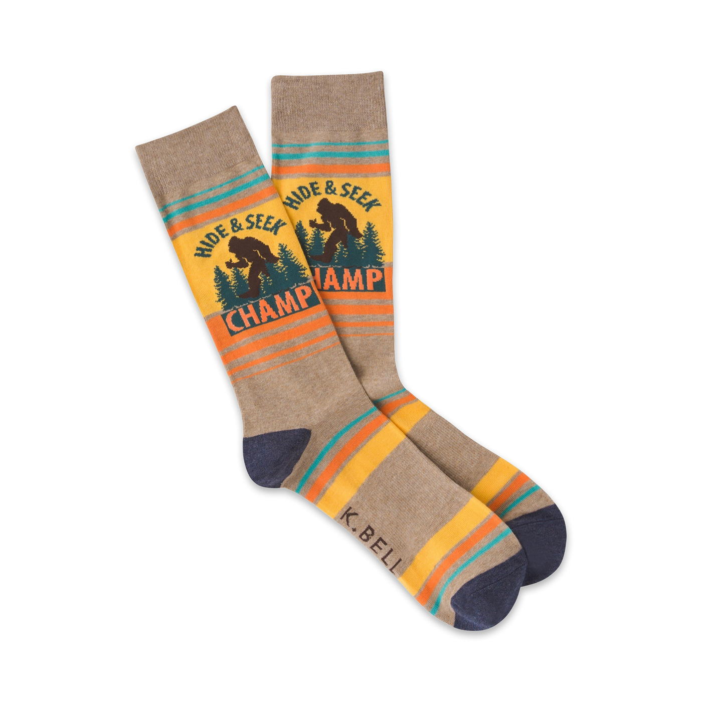 A pair of crew socks in taupe, yellow, and teal. They feature a Bigfoot graphic and the words 'Hide & Seek Champ'.