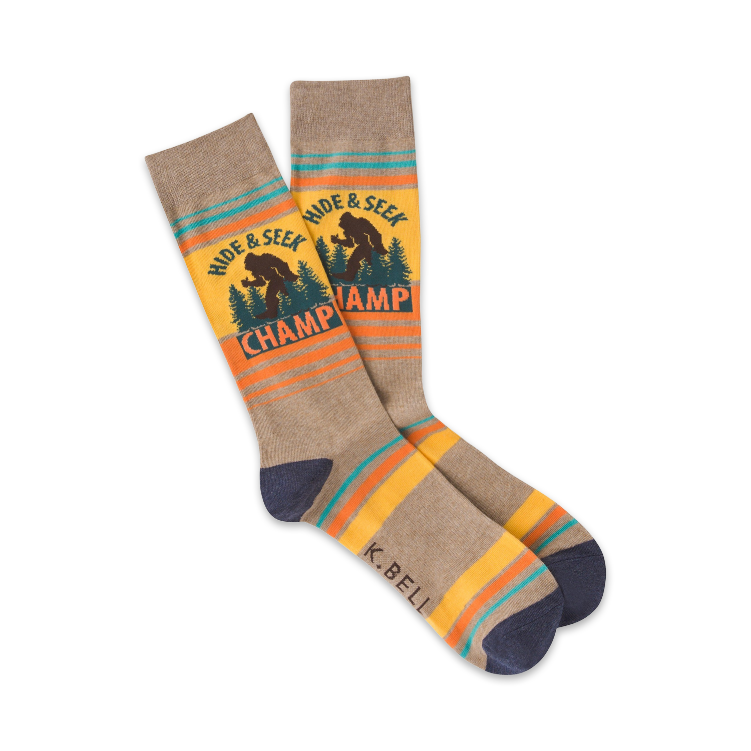 A pair of crew socks in taupe, yellow, and teal. They feature a Bigfoot graphic and the words 'Hide & Seek Champ'.