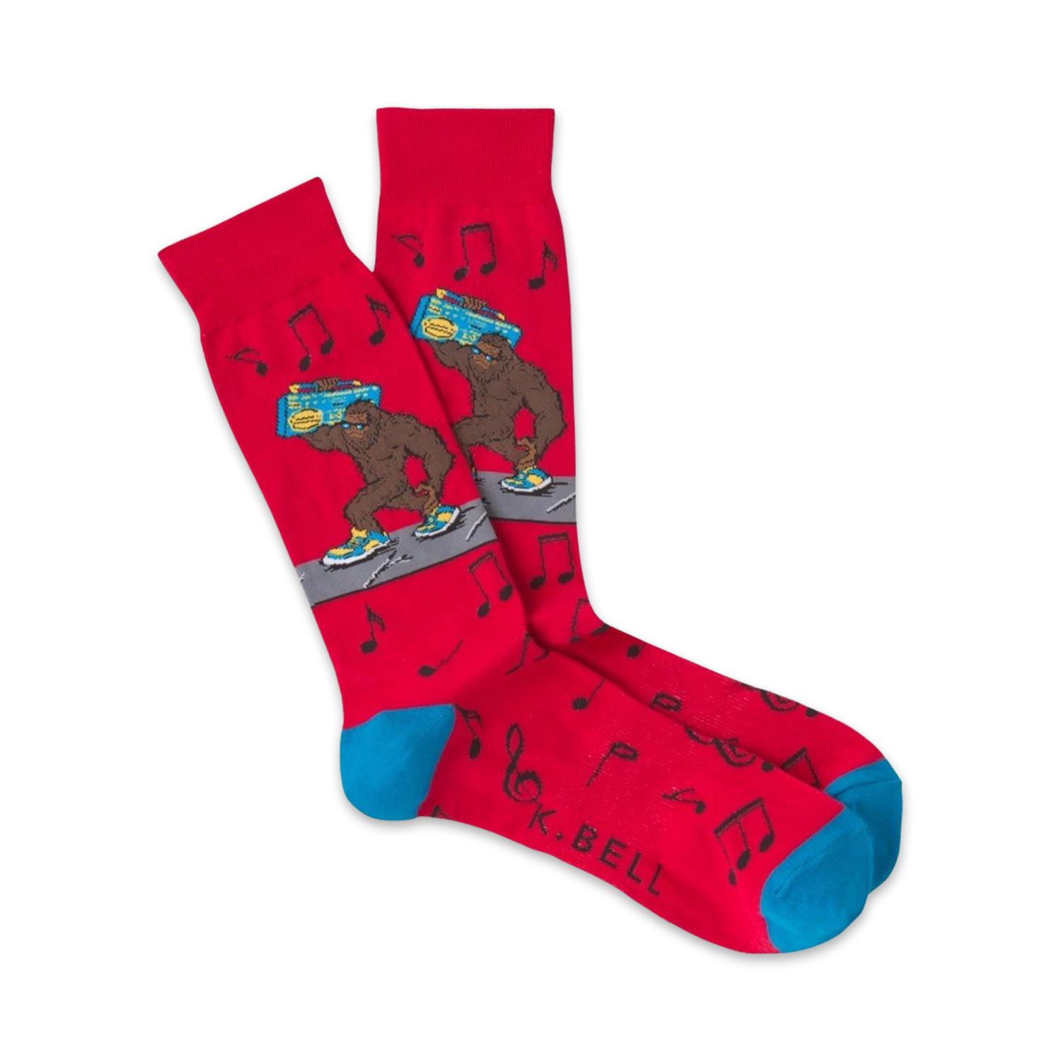 Pair of red crew socks with a cartoon Bigfoot carrying a boombox.  Musical notes and teal cuffs add to the fun, 80s-inspired design.