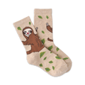 Pair of beige crew socks with brown sloths and green leaves. 