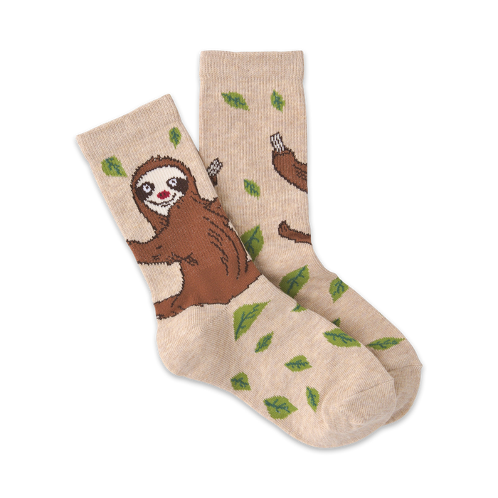 beige crew socks with a sloth pattern for kids, featuring brown sloths with pink noses hanging from green leaves.    }}