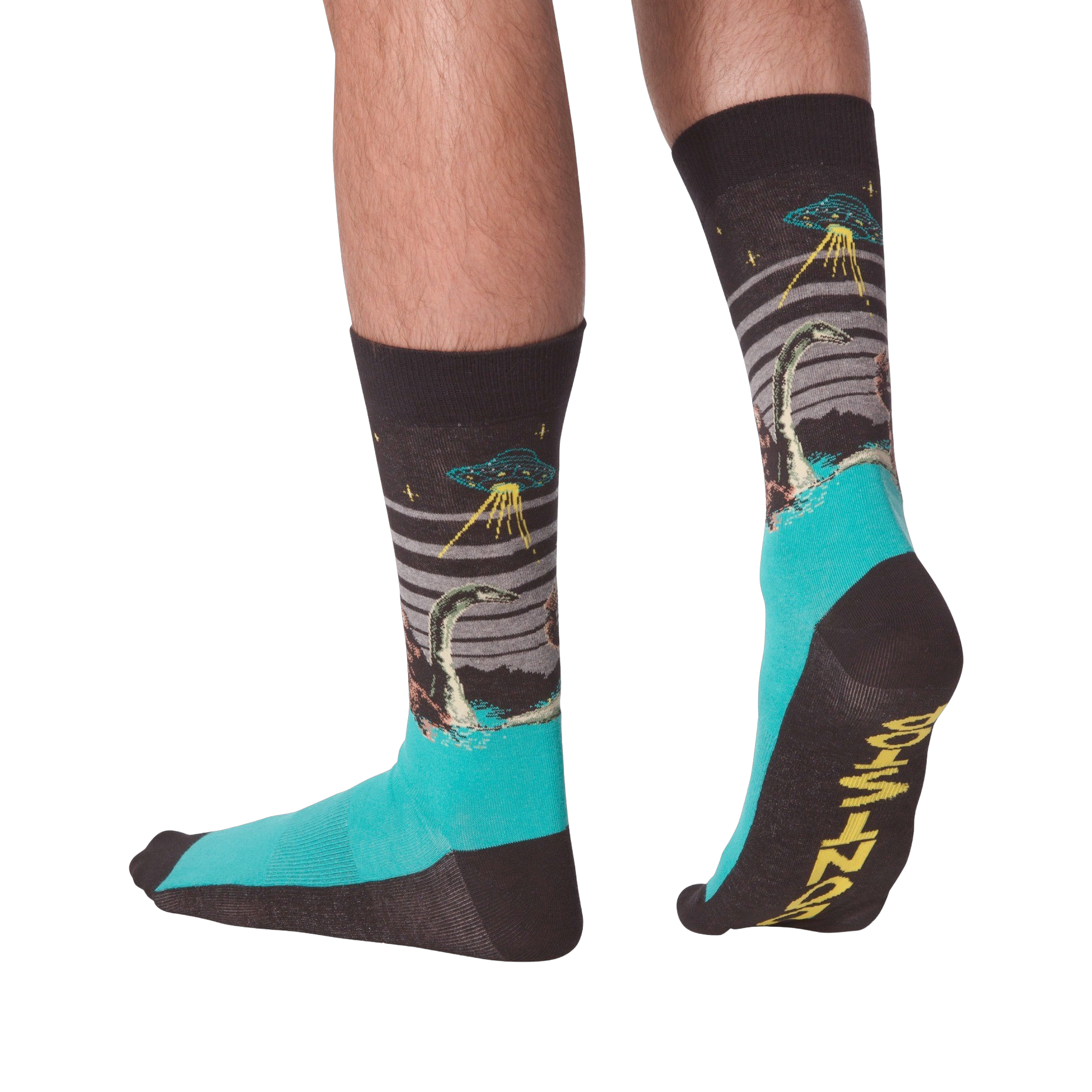 Pair of crew socks worn on legs, showing a dark grey upper with Loch Ness Monster, UFO, and teal feet.