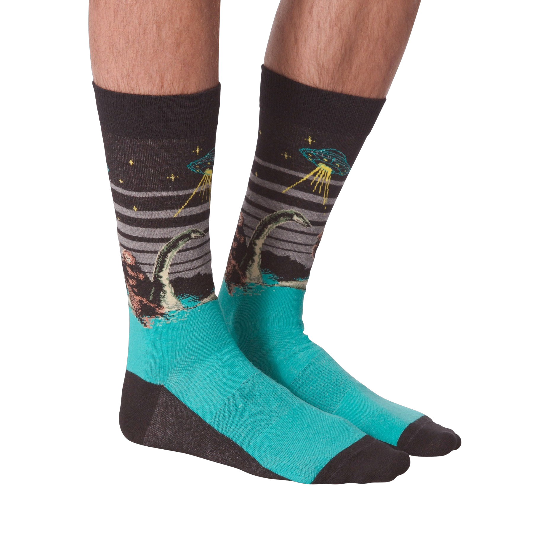 Pair of crew socks worn on legs, showing Bigfoot, Loch Ness Monster, and a UFO on a dark grey background with teal feet.