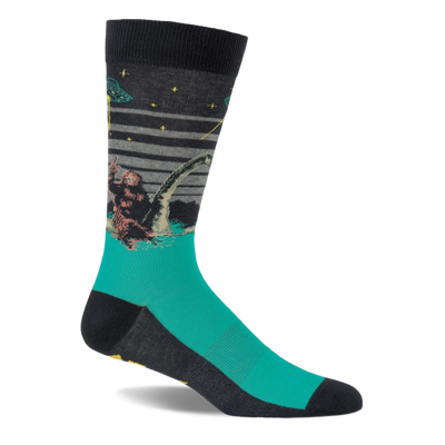 Single crew sock with dark grey top and teal foot, depicting Bigfoot, Loch Ness Monster, and a UFO at night.