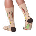 Lifestyle shot:  Person wearing tan Fishing Lure socks, showcasing the design from the back.