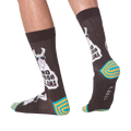 Lifestyle shot of 'No Prob Llama' socks on a person's feet. Shows the socks from the side and back.