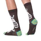 Lifestyle shot of 'No Prob Llama' socks on a person's feet. Shows the socks from the side and back.