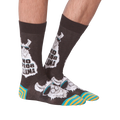Another lifestyle shot of 'No Prob Llama' socks. Shows the socks on a person's feet from an angle.