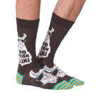 Another lifestyle shot of 'No Prob Llama' socks. Shows the socks on a person's feet from an angle.