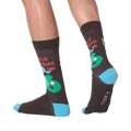 Lifestyle shot showing the 'Talk Birdie To Me' socks on a person's feet.