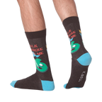 Lifestyle shot showing the 'Talk Birdie To Me' socks on a person's feet.