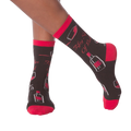 Lifestyle shot of model's legs wearing the 'Fifty Sips of Red' socks, showing the socks on feet.