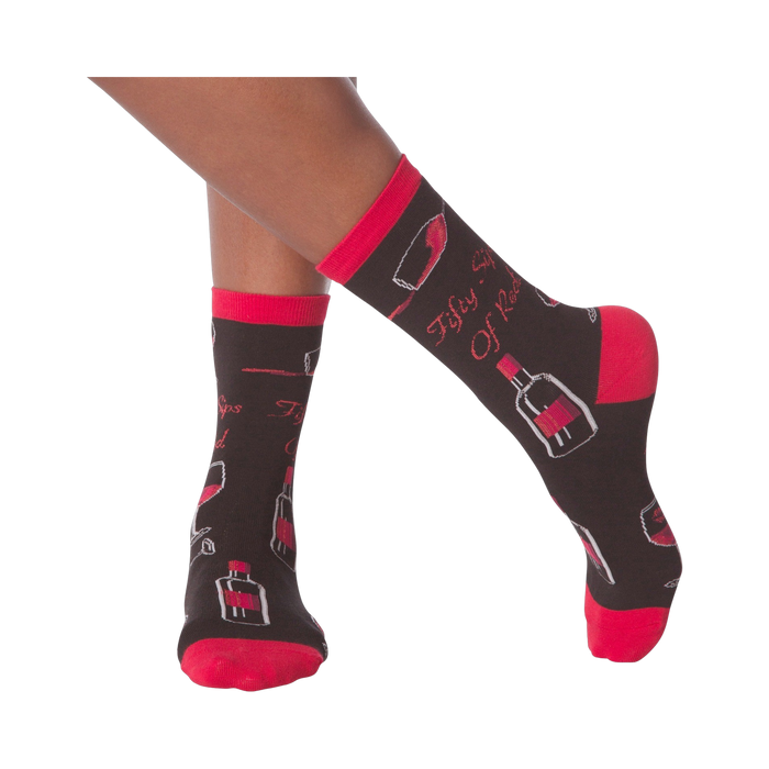 Lifestyle shot of model's legs wearing the 'Fifty Sips of Red' socks, showing the socks on feet.