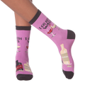 Lifestyle shot: 'I Go Both Ways' socks on a person's legs against a black background. 