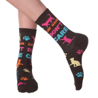 Lifestyle shot of a person wearing the 'Cat Hair Don't Care' socks. The socks are shown from the ankle to mid-calf.