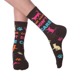 Lifestyle shot of a person wearing the 'Cat Hair Don't Care' socks. The socks are shown from the ankle to mid-calf.