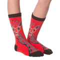 Another lifestyle shot of the red socks with the giraffe pattern on a person's feet.