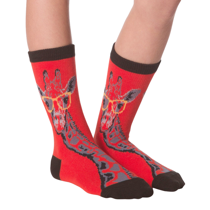 Another lifestyle shot of the red socks with the giraffe pattern on a person's feet.