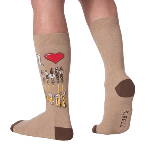 Lifestyle shot of a person wearing the tan 'Draft Beer' socks. The design is partially visible.