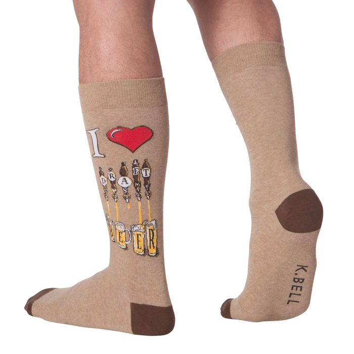 Lifestyle shot of a person wearing the tan 'Draft Beer' socks. The design is partially visible.