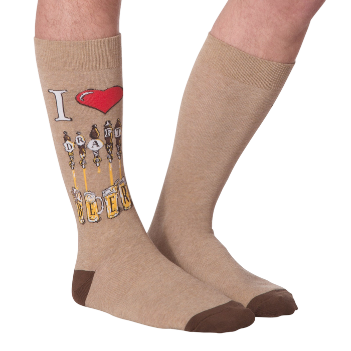 Flat lay of a pair of tan 'Draft Beer' socks showing the full design, including the 'I heart Draft Beer' graphic and beer tap image.