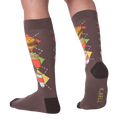 Back view of a person wearing the Junk Food socks, showcasing the full design on the leg.