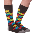 Flat lay showcasing both socks with the colorful puzzle piece design.