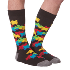 Flat lay showcasing both socks with the colorful puzzle piece design.