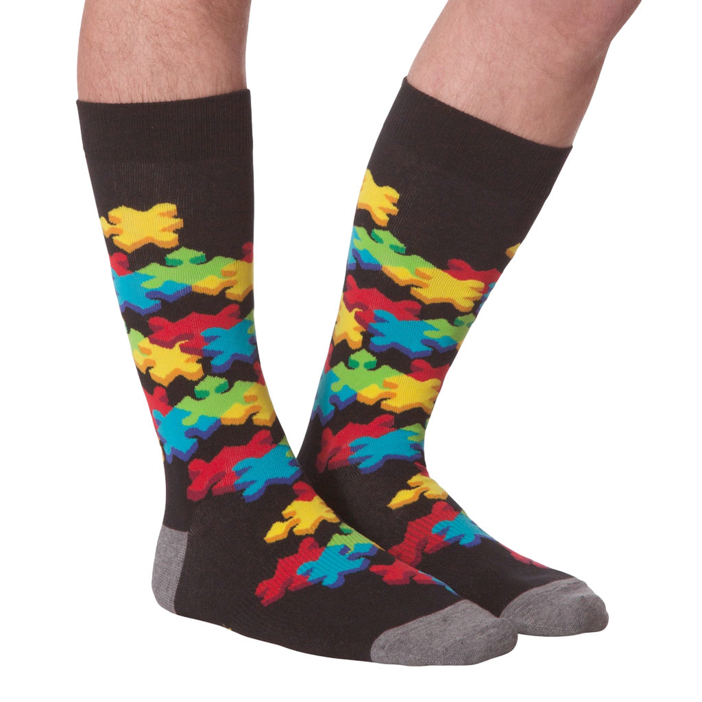 Flat lay showcasing both socks with the colorful puzzle piece design.