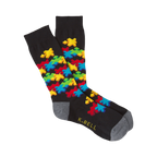 Black crew socks with a colorful 3D puzzle piece design.  Features red, yellow, blue, and green puzzle pieces.