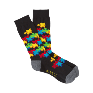 Black crew socks with a colorful 3D puzzle piece design.  Features red, yellow, blue, and green puzzle pieces.