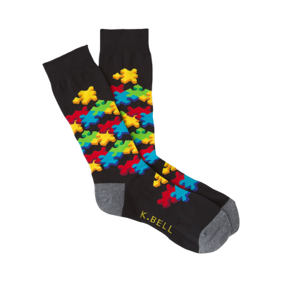 Black crew socks with a colorful 3D puzzle piece design.  Features red, yellow, blue, and green puzzle pieces.