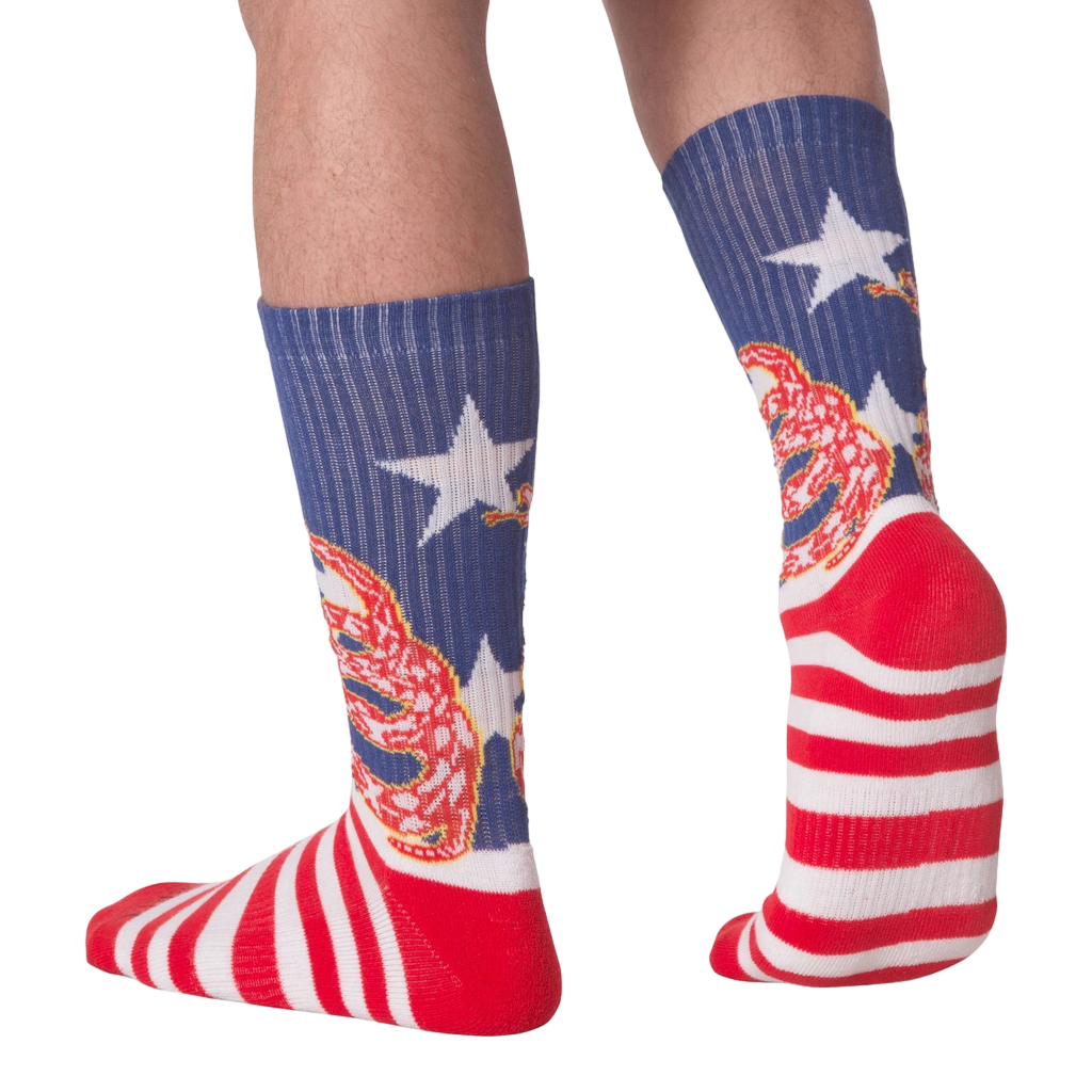 Rear view of 'Don't Tread' socks on a person's legs.