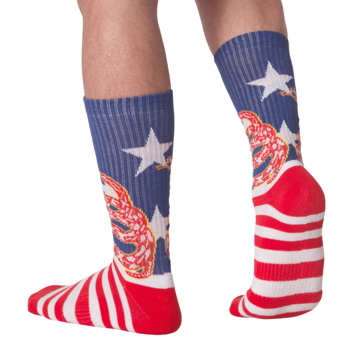 Rear view of 'Don't Tread' socks on a person's legs.