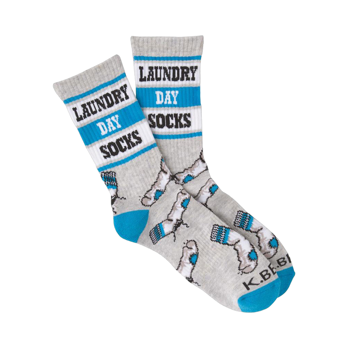 A pair of grey crew socks with teal accents. The socks have 'Laundry Day Socks' written on them and a pattern of small grey socks. }}