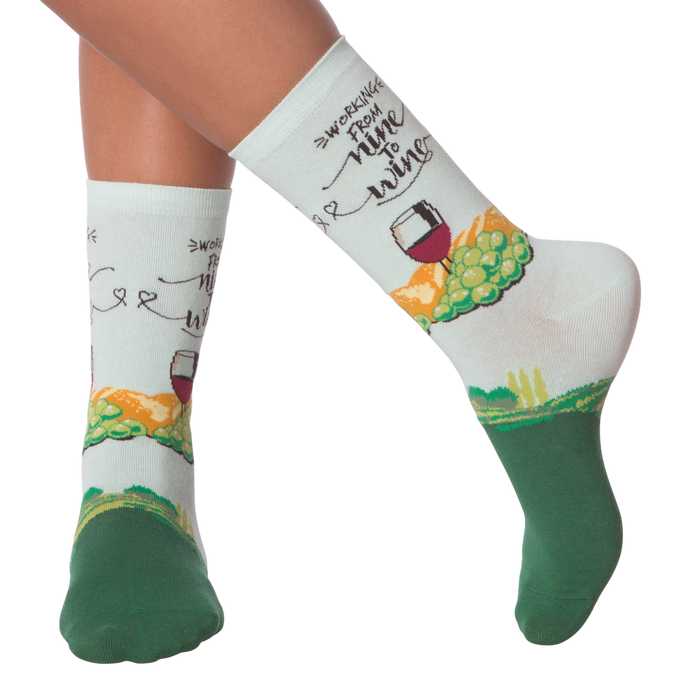 Lifestyle shot showing 'Nine to Wine' socks on a person's legs.