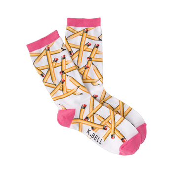 A pair of white crew socks with a playful pattern of yellow pencils scattered across them.  The socks have hot pink cuffs.