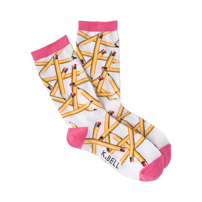 A pair of white crew socks with a playful pattern of yellow pencils scattered across them.  The socks have hot pink cuffs. }}