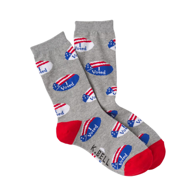 Crew socks in gray with a pattern of small red, white, and blue 'I Voted' stickers. The heel and toe are red.