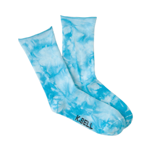 Lifestyle shot showing the light blue tie-dye socks on a model's feet.