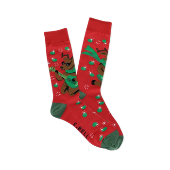 Pair of red crew socks with green cuffs, heels, and toes, featuring brown reindeer in sunglasses playing green guitars with starbursts and green ovals.