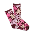 A pair of maroon crew socks with a scattered pink and beige cannabis leaf pattern. The socks are folded to show both sides of the design. K.BELL is subtly printed on one sock.