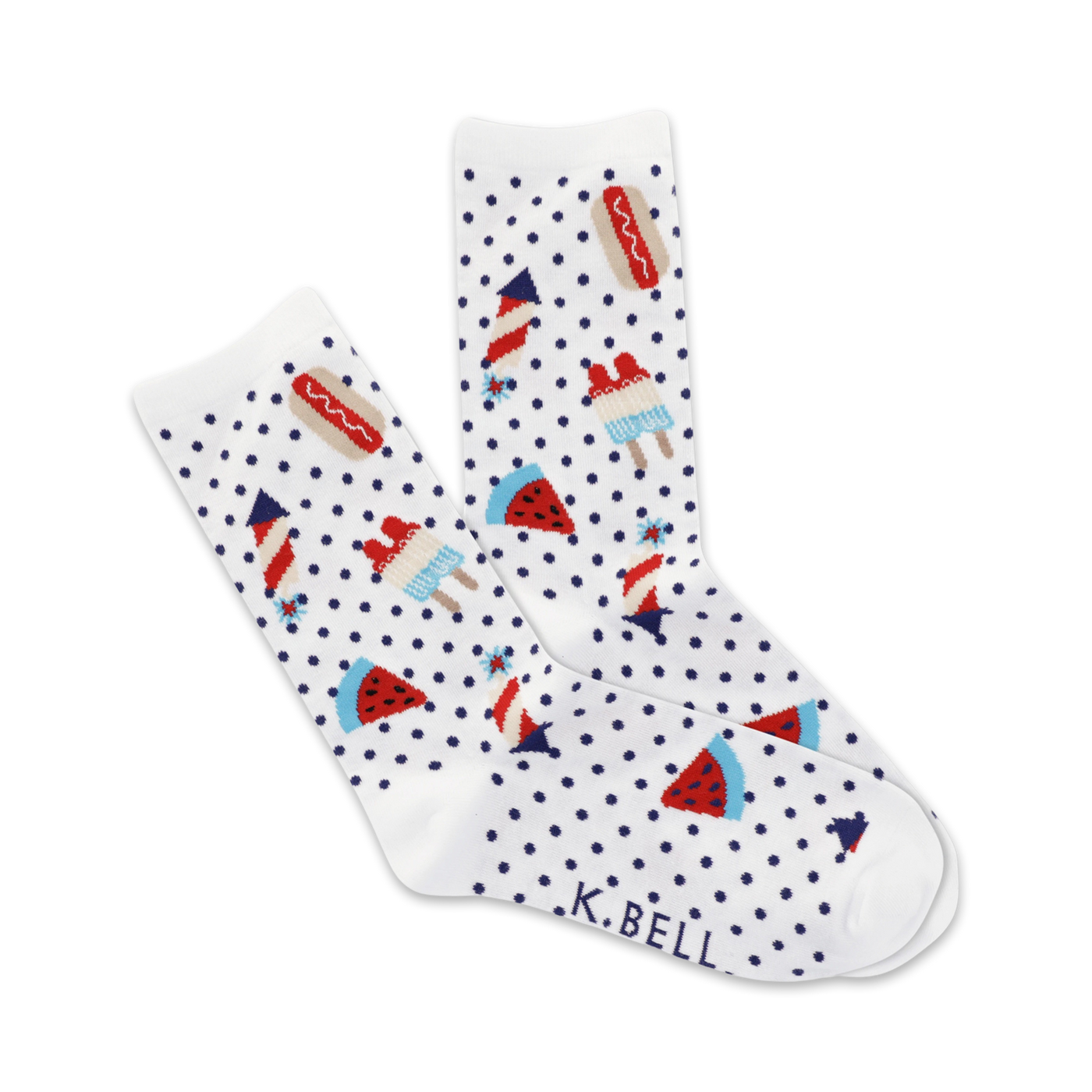 A pair of white crew socks with a navy polka dot pattern and fun summer picnic themed designs: hot dogs, watermelon slices, ice pops and fireworks.