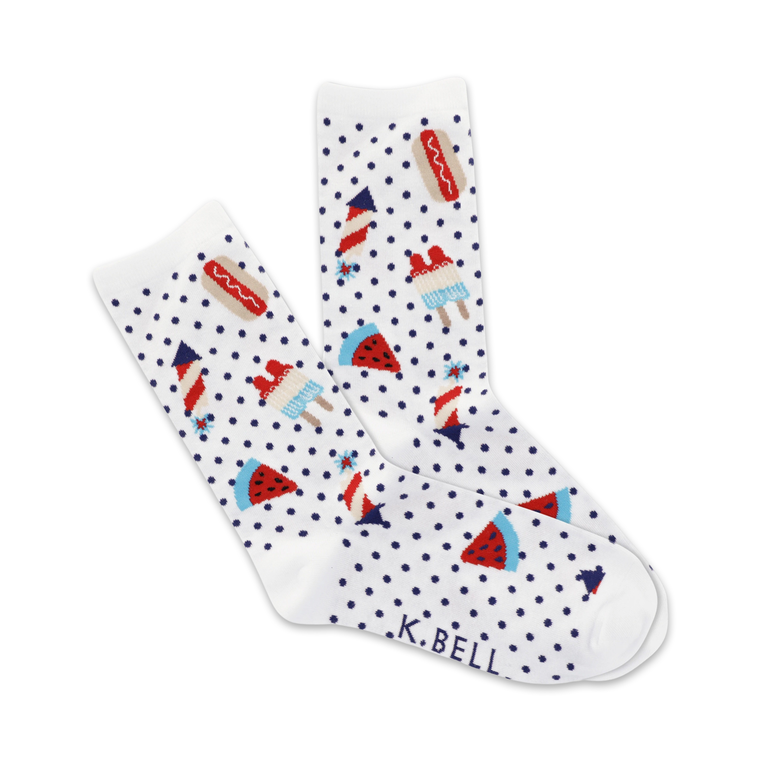 A pair of white crew socks with a navy polka dot pattern and fun summer picnic themed designs: hot dogs, watermelon slices, ice pops and fireworks.